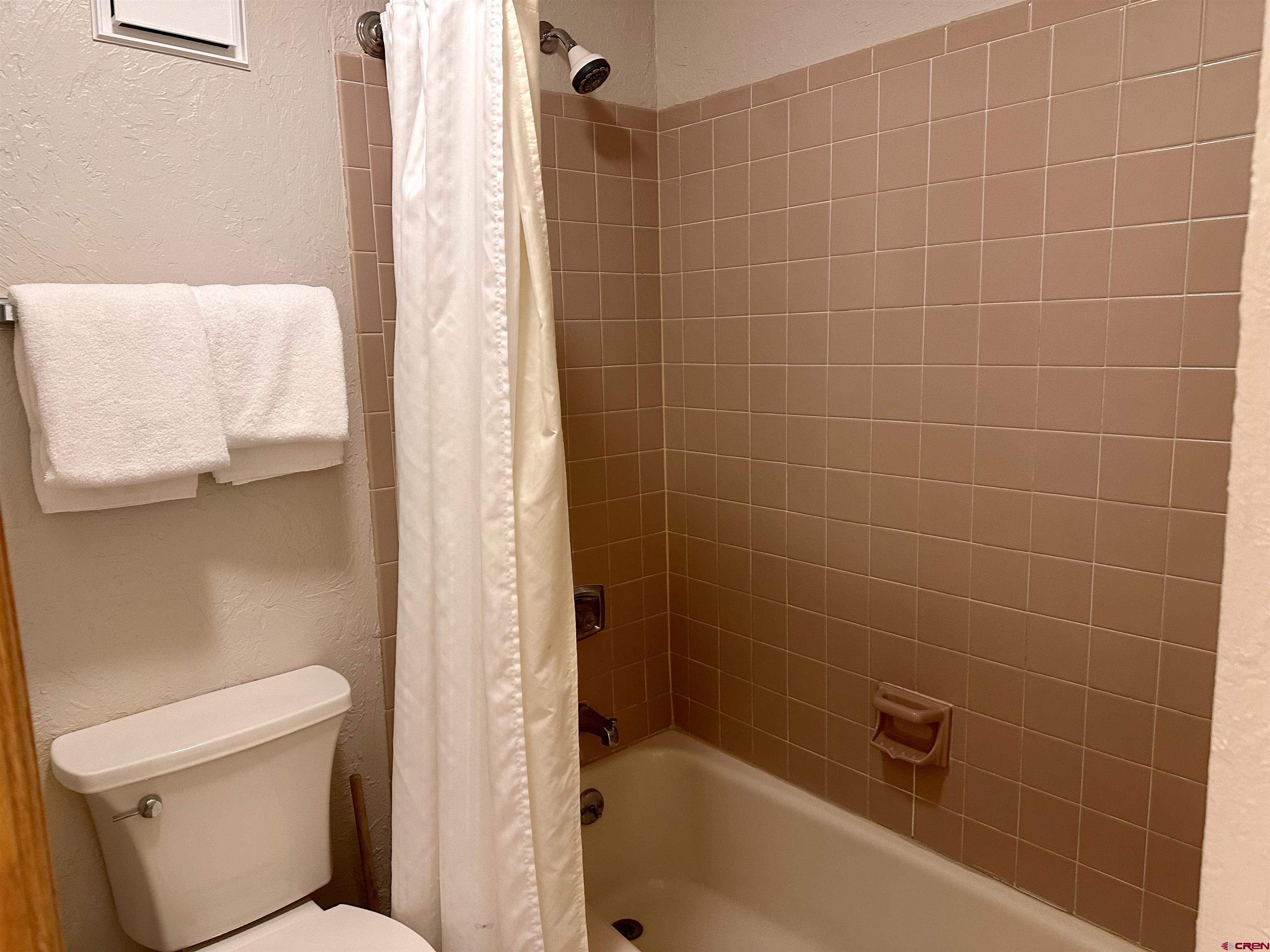 71 Needles Way, Unit 441 Durango, CO 81301 - Photo 20 of 39 a bathroom with a bathtub and a toilet