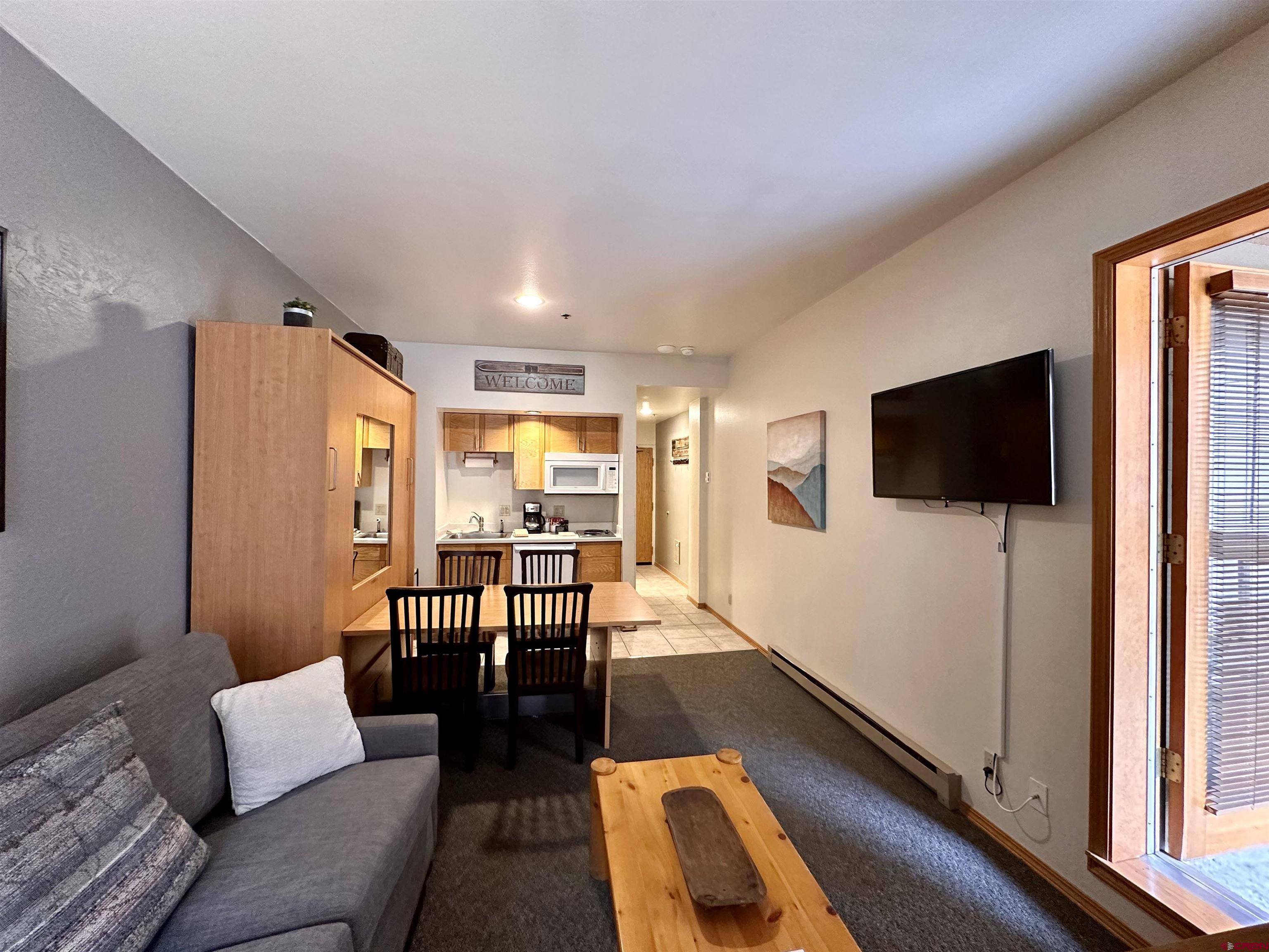 71 Needles Way, Unit 441 Durango, CO 81301 - Photo 3 of 39 a living room with furniture and a flat screen tv