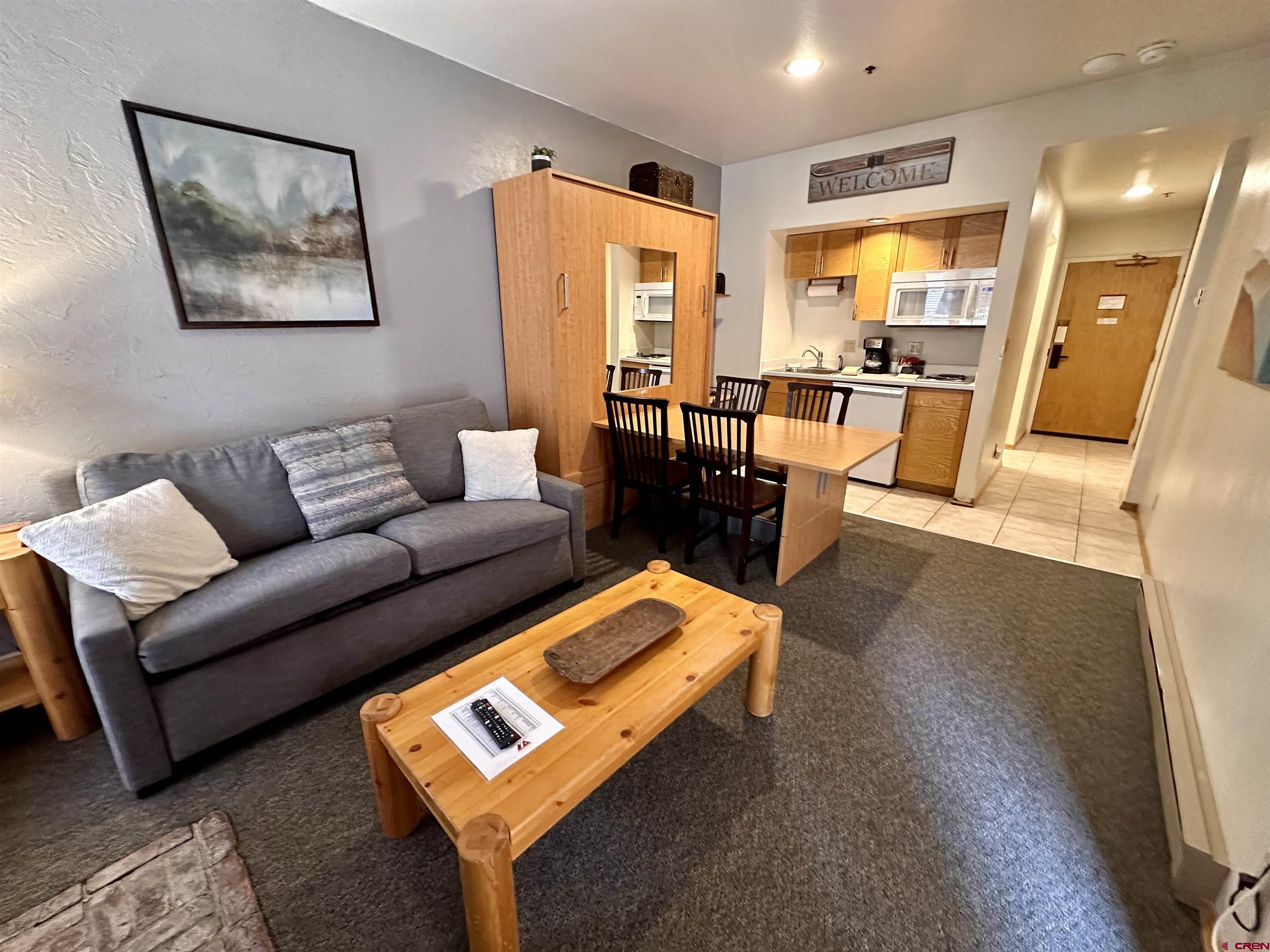 71 Needles Way, Unit 441 Durango, CO 81301 - Photo 5 of 39 a living room with furniture and a table