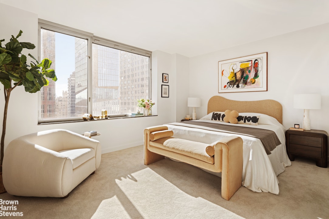 150 Columbus Avenue, Unit 18F Manhattan, NY 10023 - Photo 12 of 22 a spacious bedroom with a bed and a large window