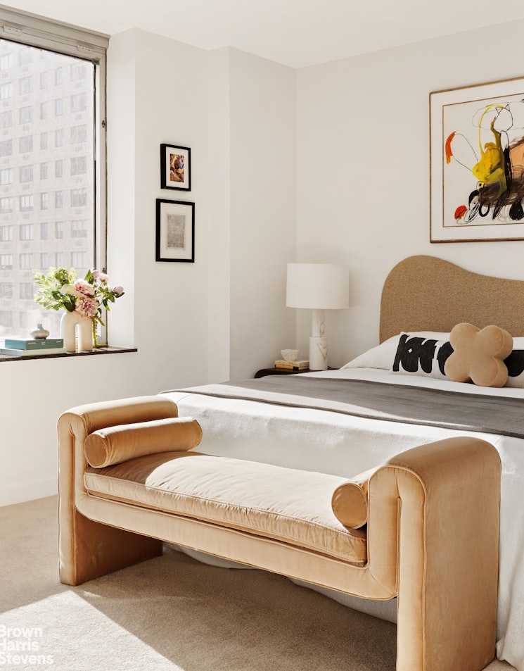 150 Columbus Avenue, Unit 18F Manhattan, NY 10023 - Photo 14 of 22 a spacious bedroom with a bed and couch