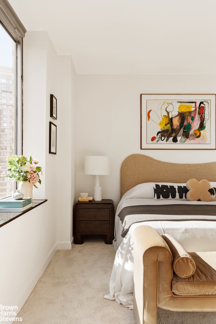 150 Columbus Avenue, Unit 18F Manhattan, NY 10023 - Photo 15 of 22 a bedroom with a bed and cupboard