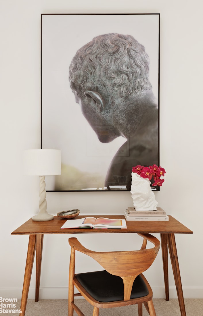 150 Columbus Avenue, Unit 18F Manhattan, NY 10023 - Photo 16 of 22 a table with a vase and flowers on it