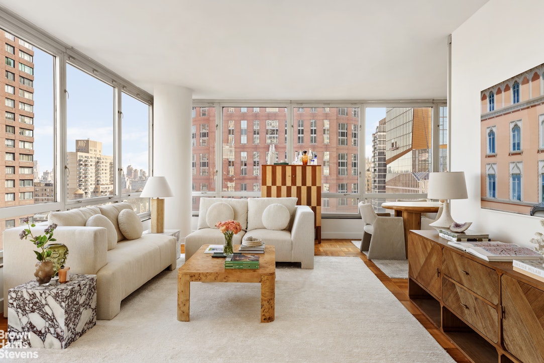 150 Columbus Avenue, Unit 18F Manhattan, NY 10023 - Photo 1 of 22 a living room with furniture and a large window