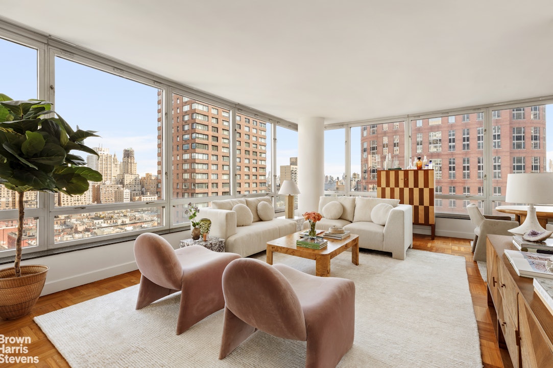 150 Columbus Avenue, Unit 18F Manhattan, NY 10023 - Photo 2 of 22 a living room with furniture and a large window