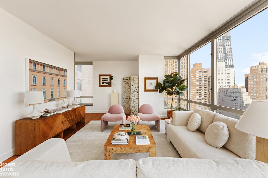 150 Columbus Avenue, Unit 18F Manhattan, NY 10023 - Photo 3 of 22 a living room with furniture and a large window