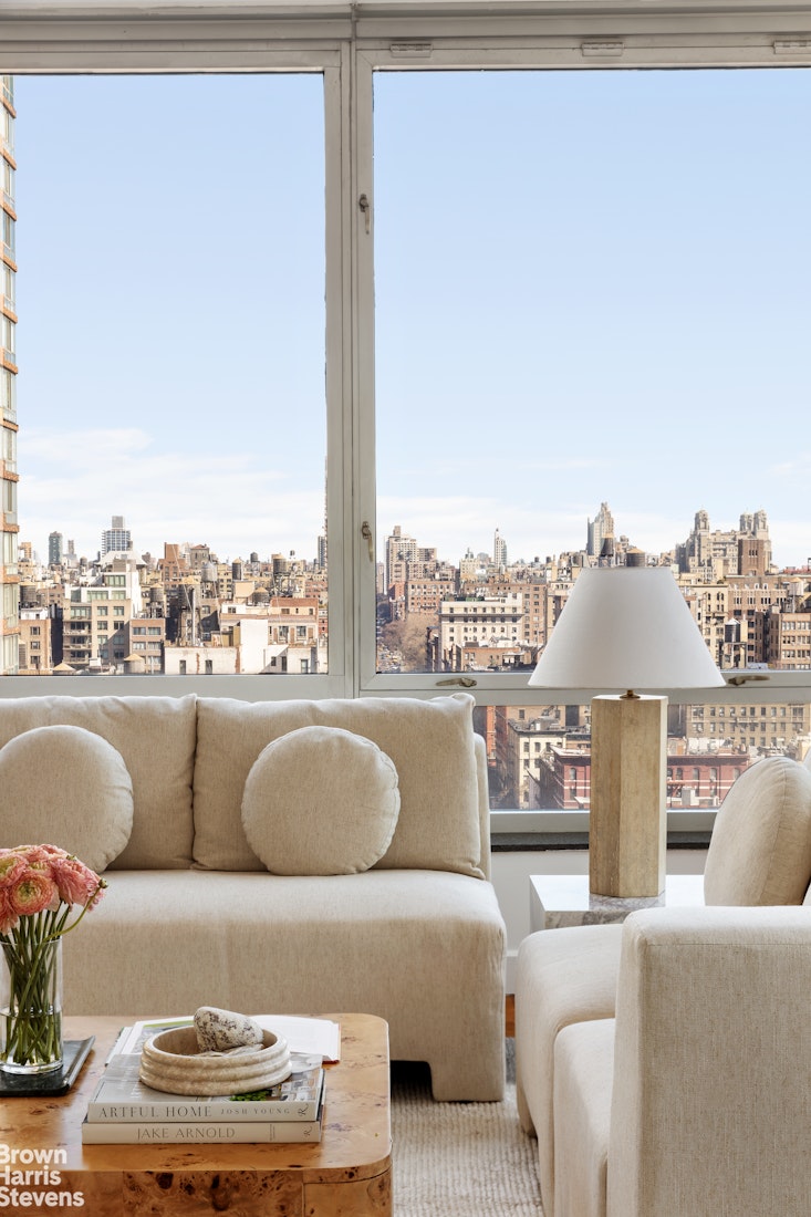 150 Columbus Avenue, Unit 18F Manhattan, NY 10023 - Photo 4 of 22 a living room with furniture and a large window