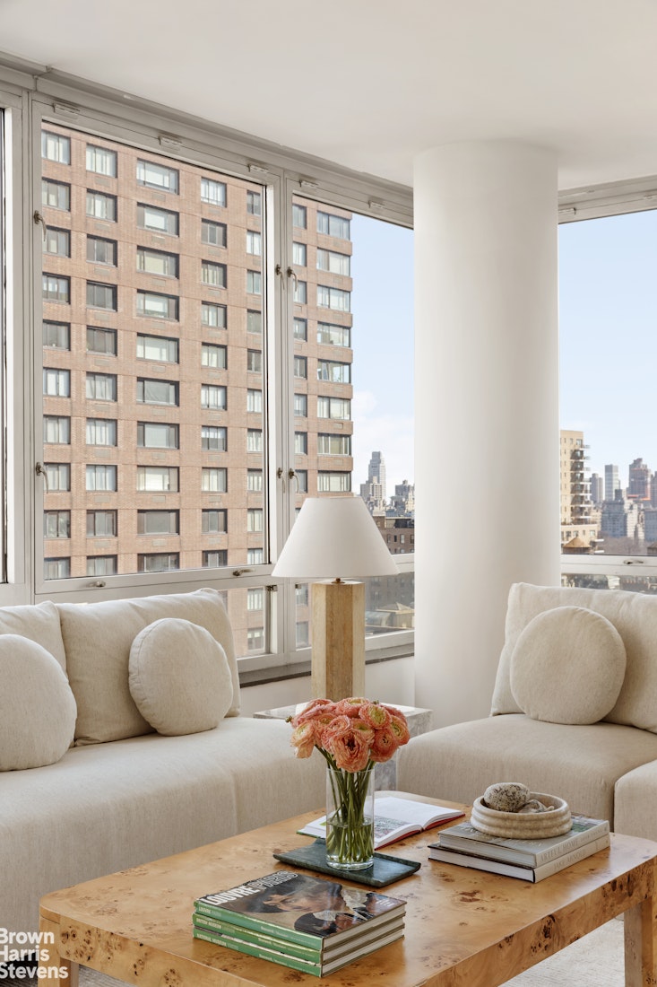 150 Columbus Avenue, Unit 18F Manhattan, NY 10023 - Photo 5 of 22 a living room with furniture and a large window