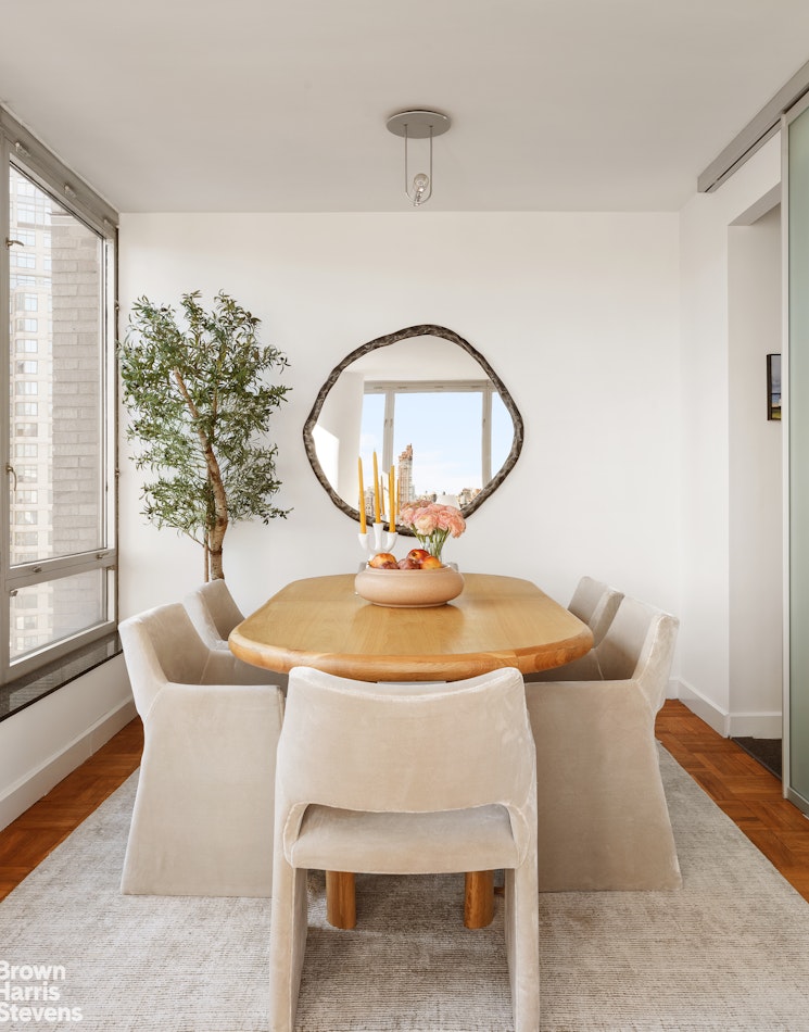 150 Columbus Avenue, Unit 18F Manhattan, NY 10023 - Photo 7 of 22 a view of a dining room with furniture and wooden floor