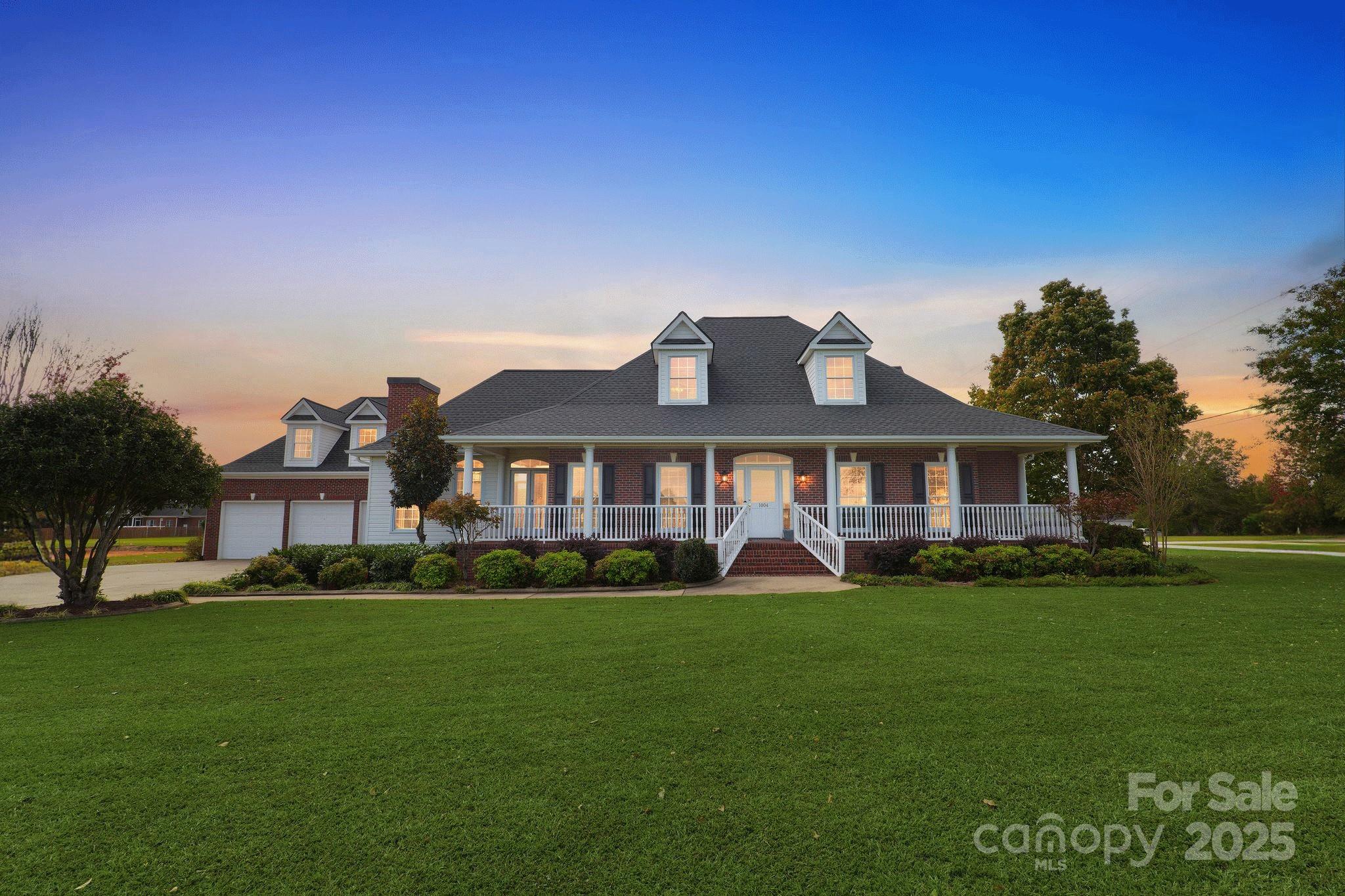 1004 Brockman Road Greer, SC 29651 - Photo 1 of 46 a front view of a house with a garden