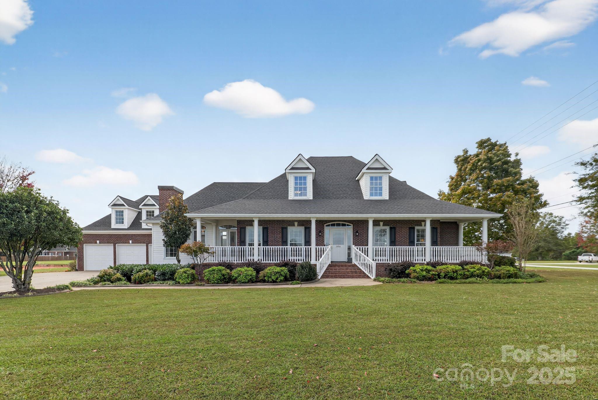 1004 Brockman Road Greer, SC 29651 - Photo 46 of 46 a front view of a house with a garden and plants