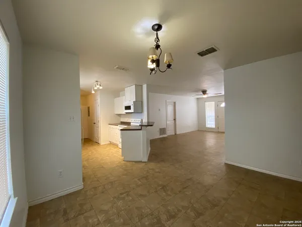 a view of a kitchen with a sink cabinets and wooden floor