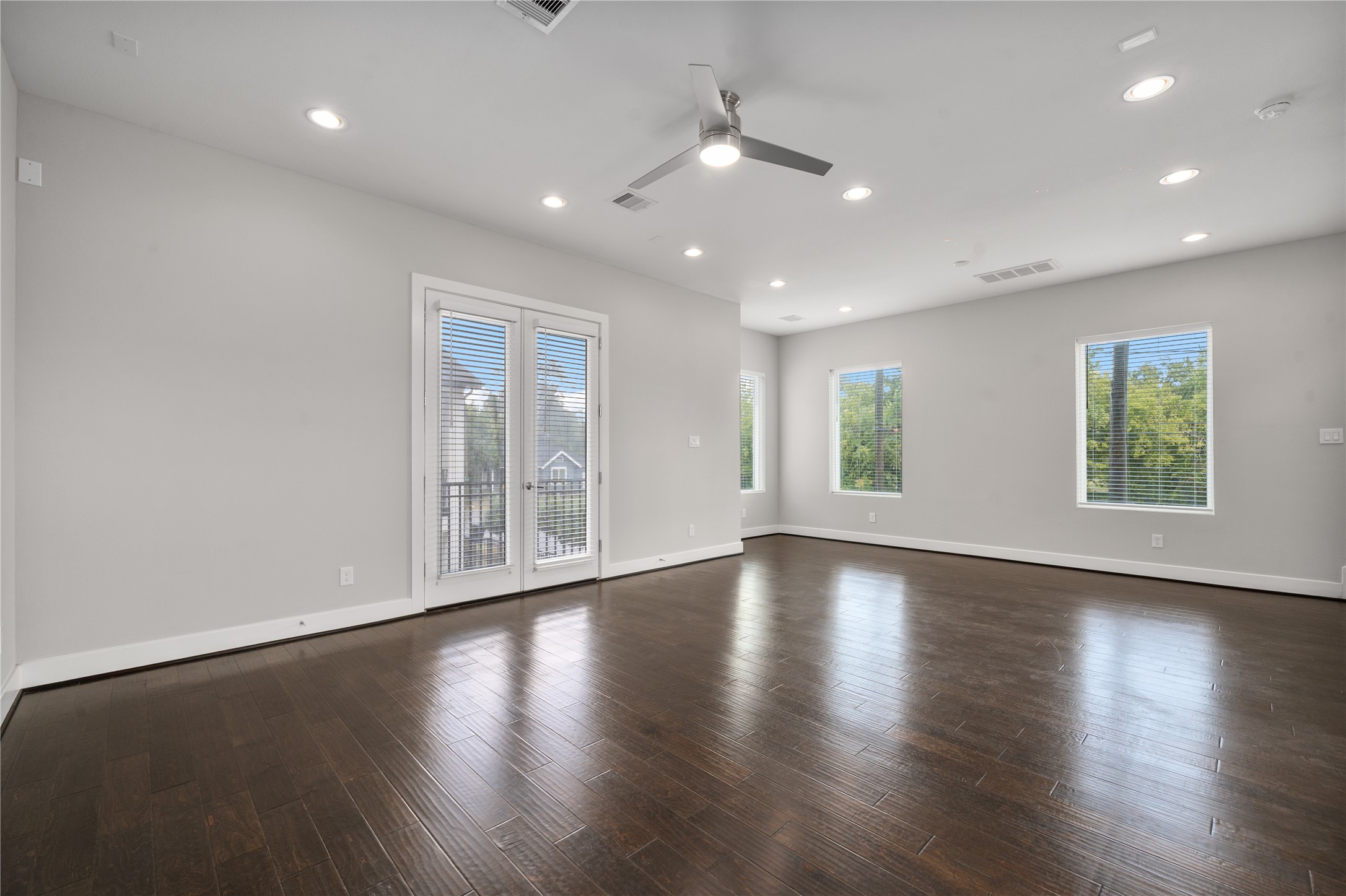 2510 Tuam Street, Unit G Houston, TX 77004 - Photo 17 of 40 an empty room with wooden floor and windows
