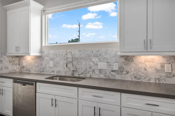 a kitchen with stainless steel appliances a sink stove and refrigerator