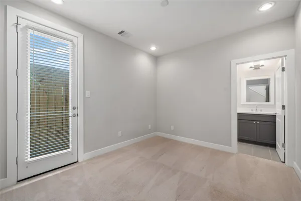 a bathroom with a granite countertop toilet a sink a mirror a bathtub and shower