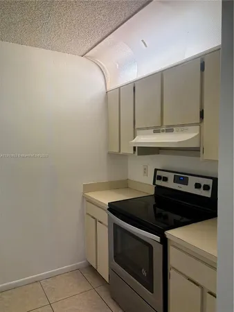a stove top oven sitting inside of a kitchen