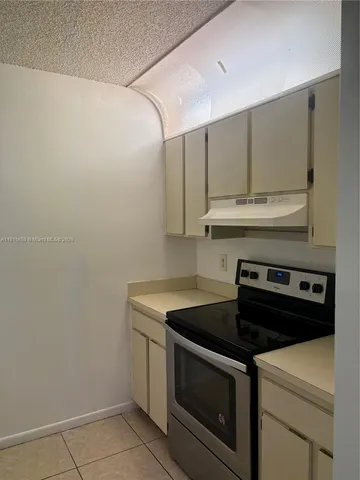 a stove top oven sitting inside of a kitchen