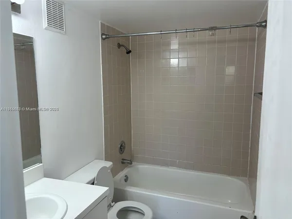 a bathroom with a shower and a toilet