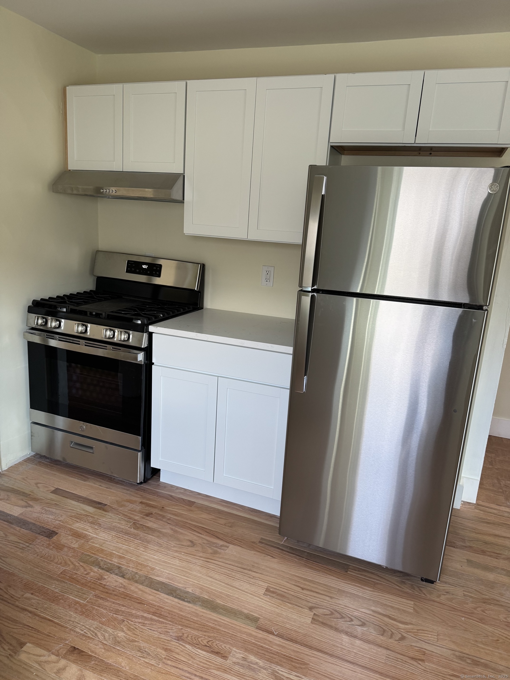 52 Pearl Street, Unit 3 New Haven, CT 06511 - Photo 2 of 12 a kitchen with a refrigerator and a stove