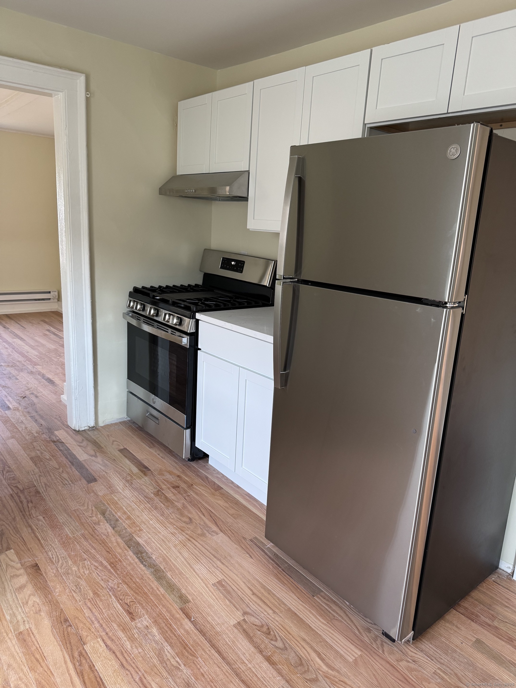 52 Pearl Street, Unit 3 New Haven, CT 06511 - Photo 4 of 12 a kitchen with a refrigerator and a stove