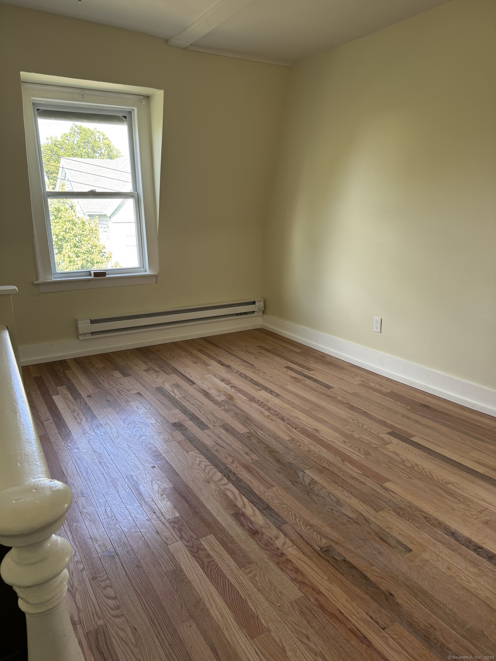 52 Pearl Street, Unit 3 New Haven, CT 06511 - Photo 6 of 12 a view of an empty room with wooden floor and a window