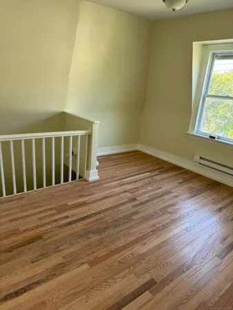 a view of wooden floor and brick walls