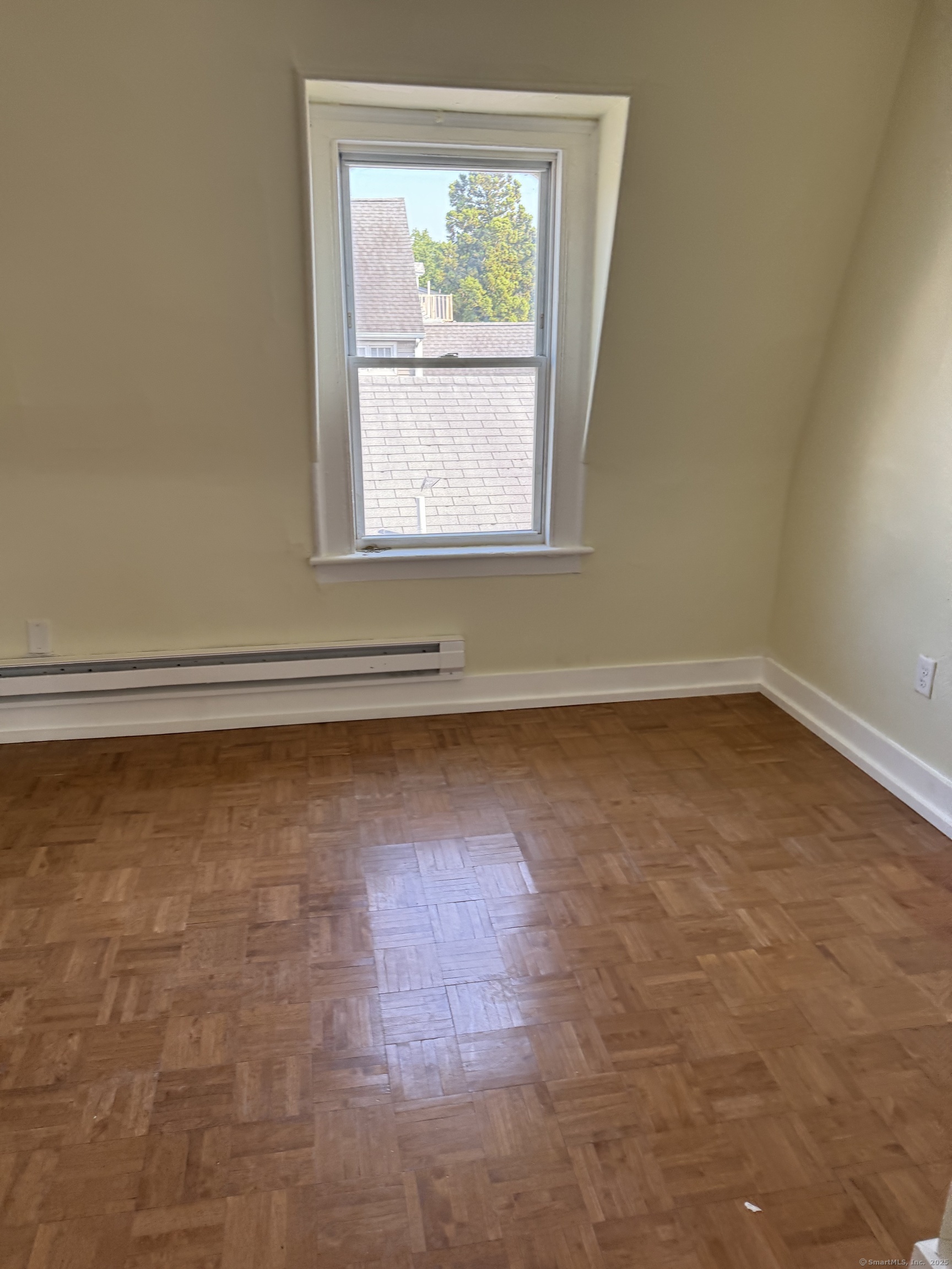 52 Pearl Street, Unit 3 New Haven, CT 06511 - Photo 9 of 12 an empty room with wooden floor and windows