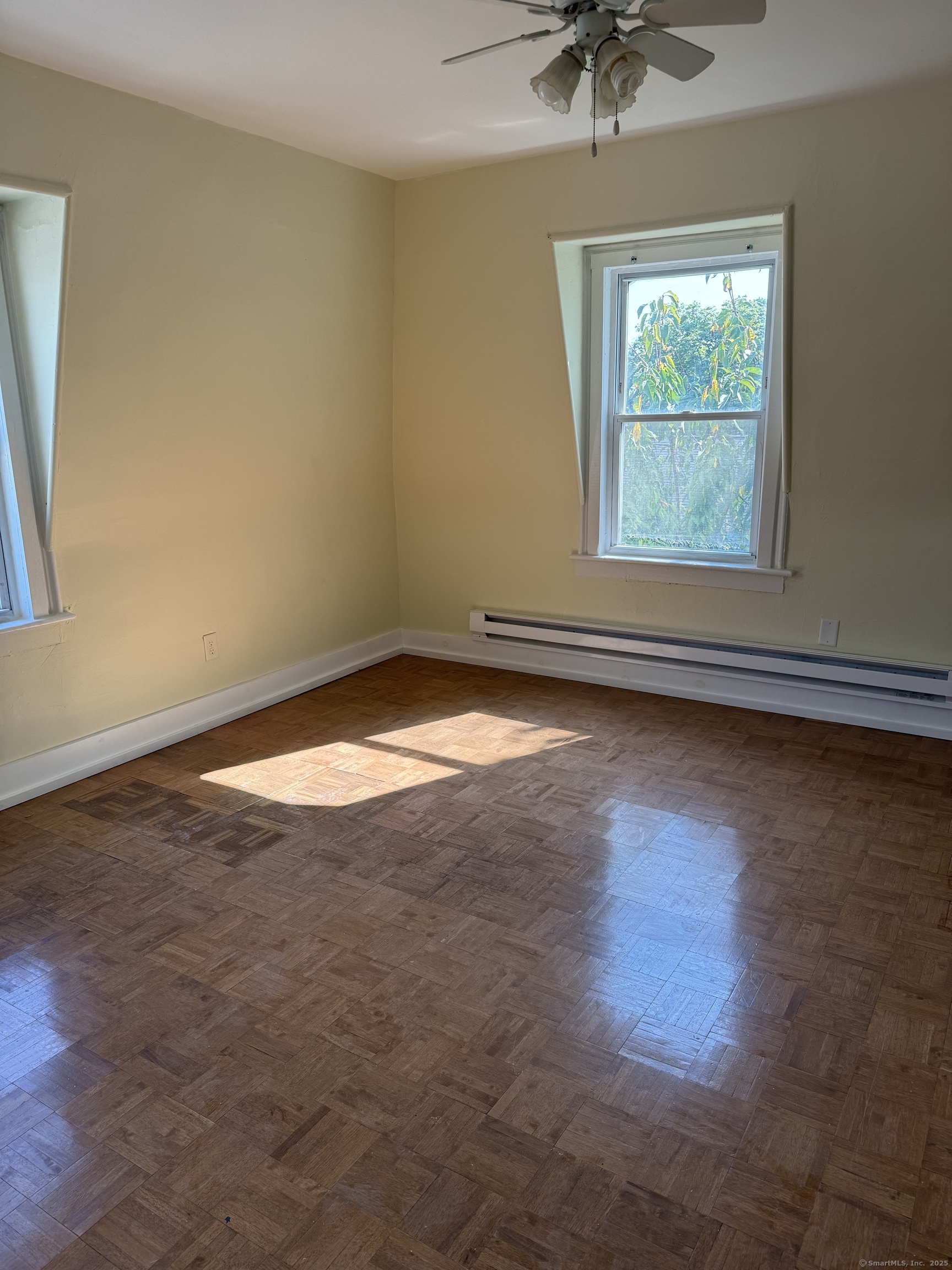 52 Pearl Street, Unit 3 New Haven, CT 06511 - Photo 10 of 12 an empty room with wooden floor and windows
