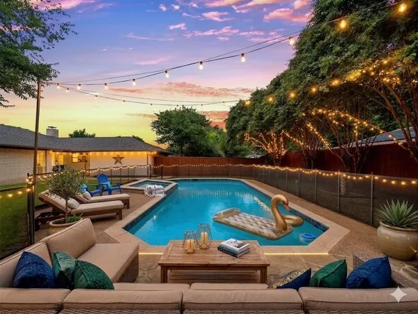 a view of a swimming pool with lounge chairs