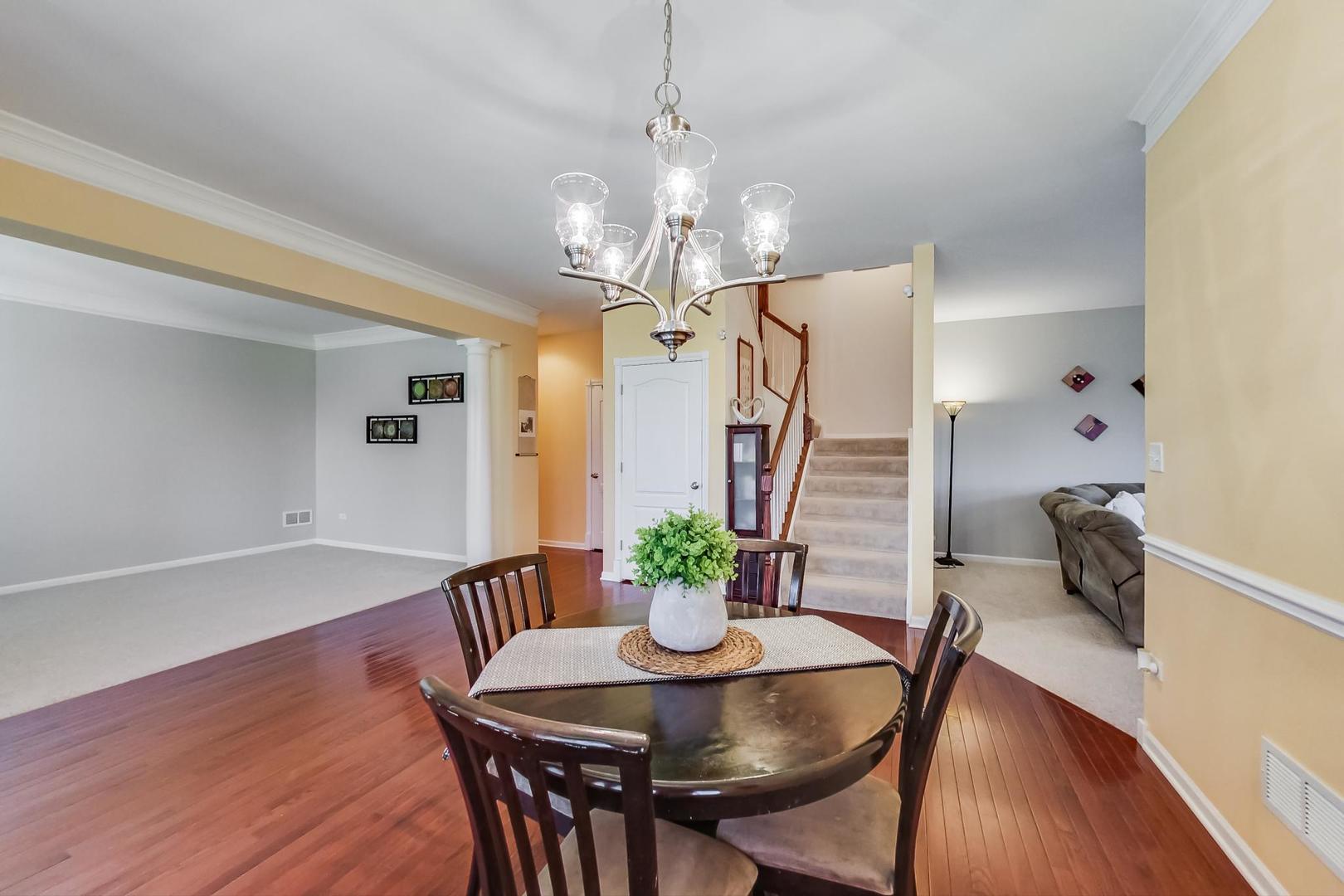 1197 Falcon Ridge Drive Elgin, IL 60124 - Photo 8 of 31 a view of a dining room with furniture and wooden floor