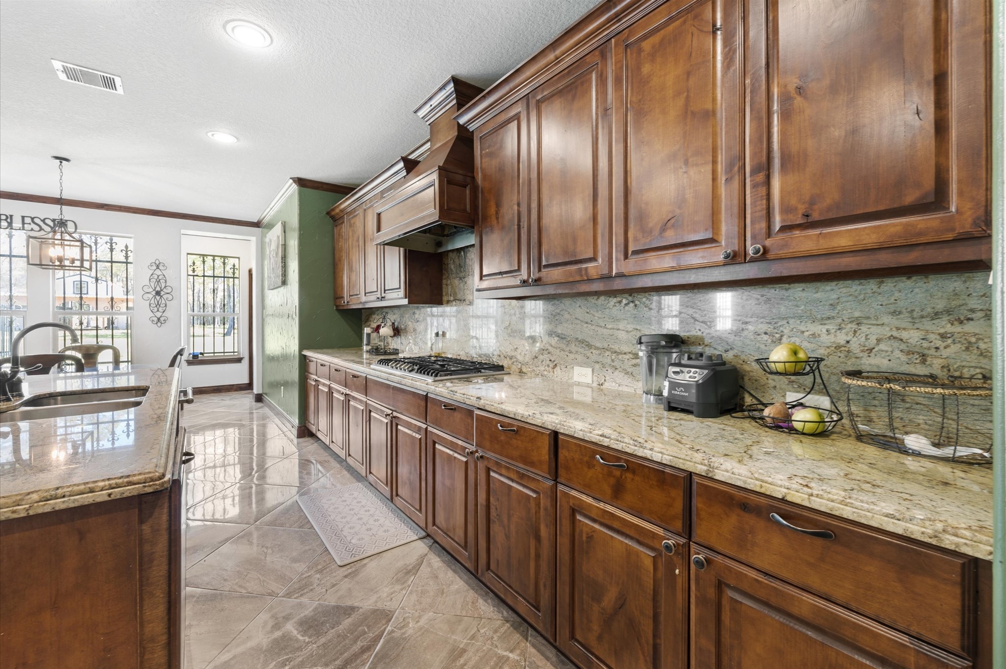 826 Oak Bend Loop Cleveland, TX 77328 - Photo 11 of 50 a kitchen with stainless steel appliances granite countertop wooden cabinets a stove top oven a sink and dishwasher