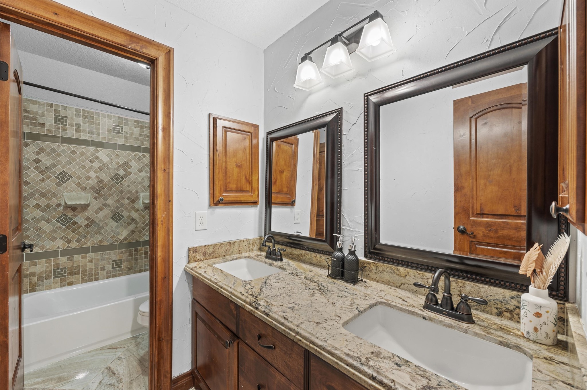 826 Oak Bend Loop Cleveland, TX 77328 - Photo 24 of 50 a bathroom with a granite countertop sink mirror and a bathtub