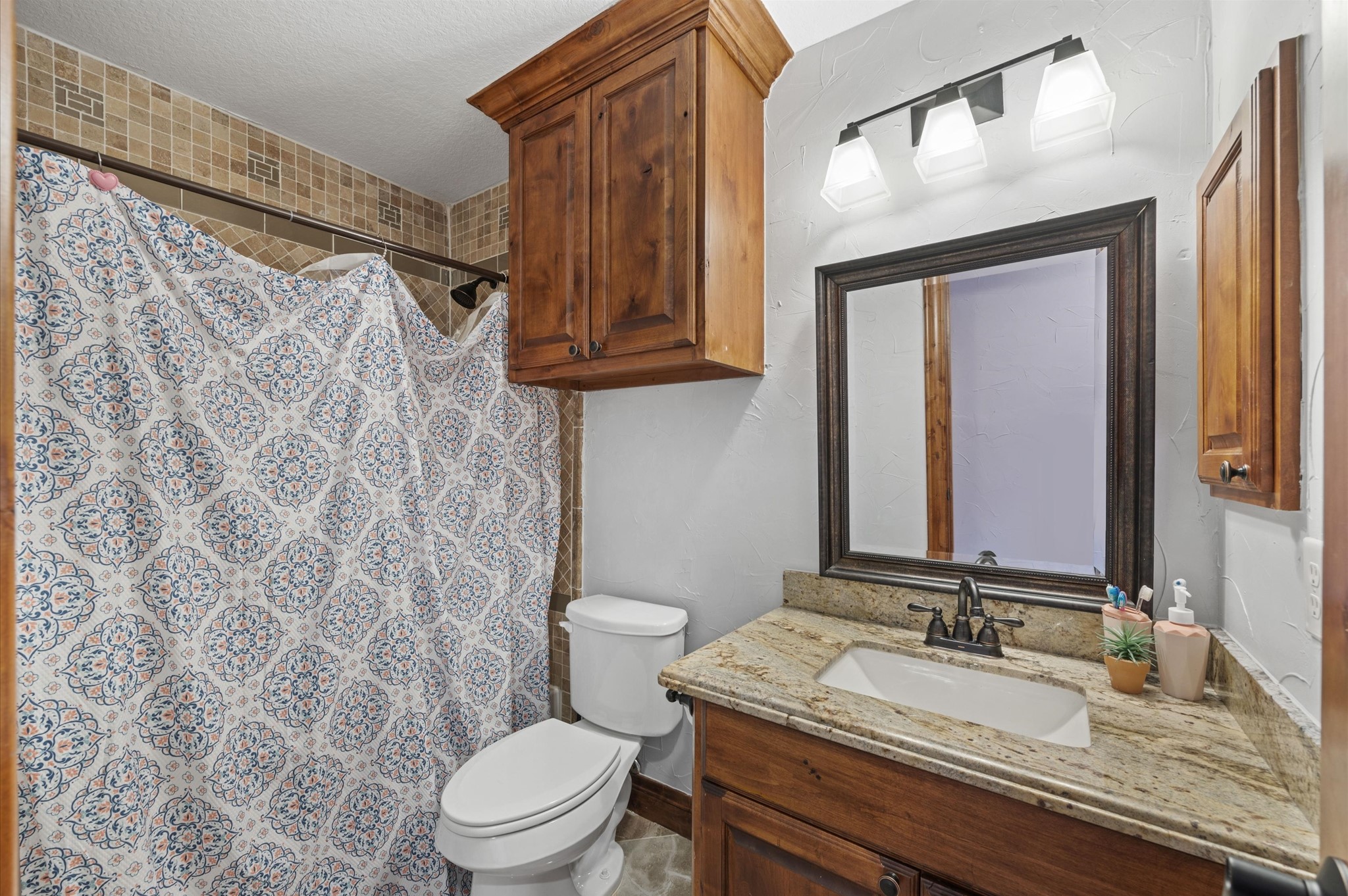 826 Oak Bend Loop Cleveland, TX 77328 - Photo 31 of 50 a bathroom with a granite countertop sink toilet and a mirror