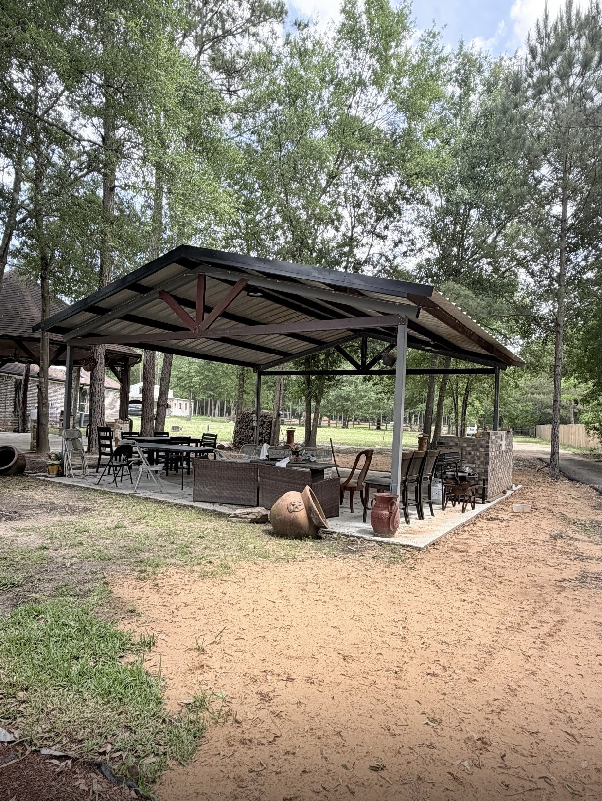 826 Oak Bend Loop Cleveland, TX 77328 - Photo 46 of 50 a view of patio with table and chairs under an umbrella with a barbeque grill and large trees