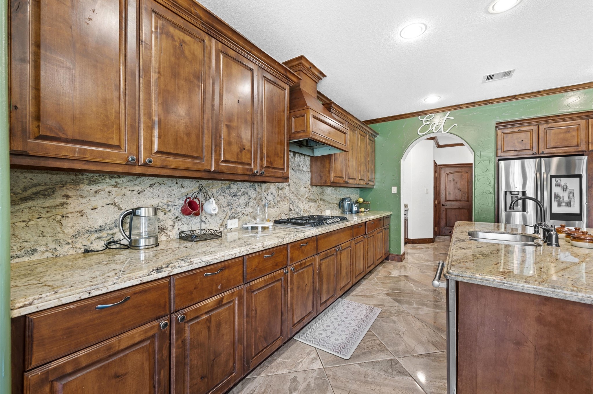826 Oak Bend Loop Cleveland, TX 77328 - Photo 10 of 50 a large kitchen with granite countertop a sink and cabinets
