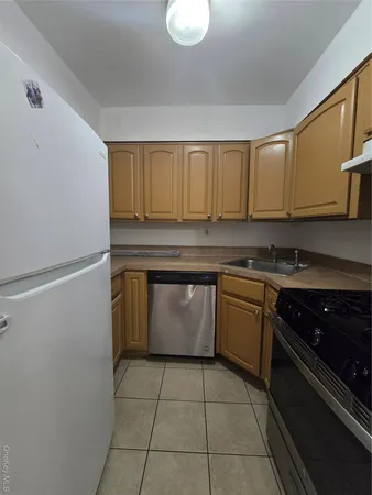 a kitchen with a stove a sink and cabinets