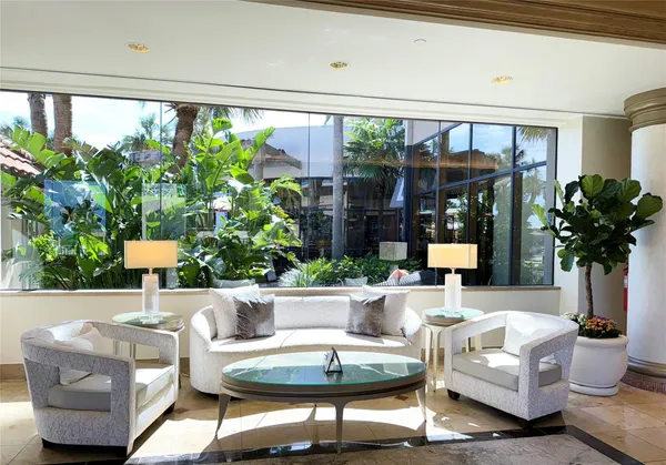 a living room with furniture and a potted plant