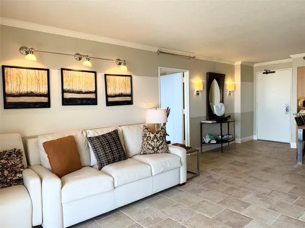 a living room with furniture and a mirror