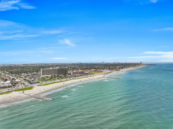 a view of a living room with a large window and chandelier