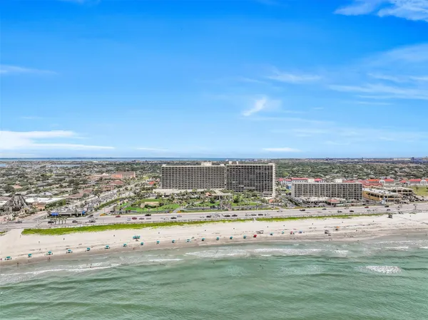 an aerial view of a wooden chairs and fire pit
