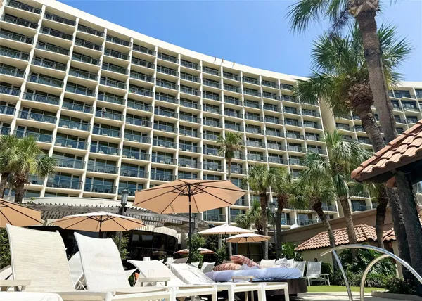 a view of balcony with table and chairs