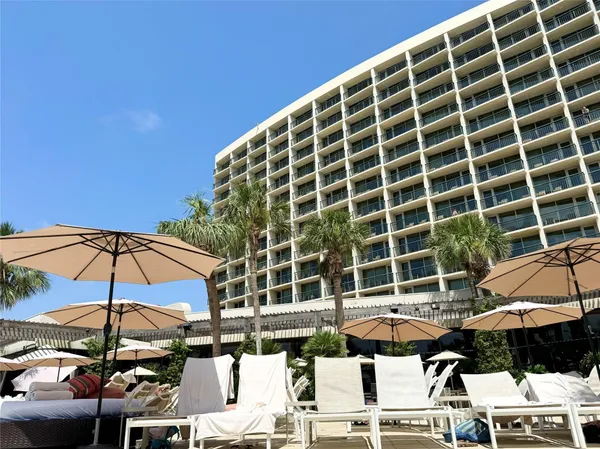 a view of a dry yard with wooden fence