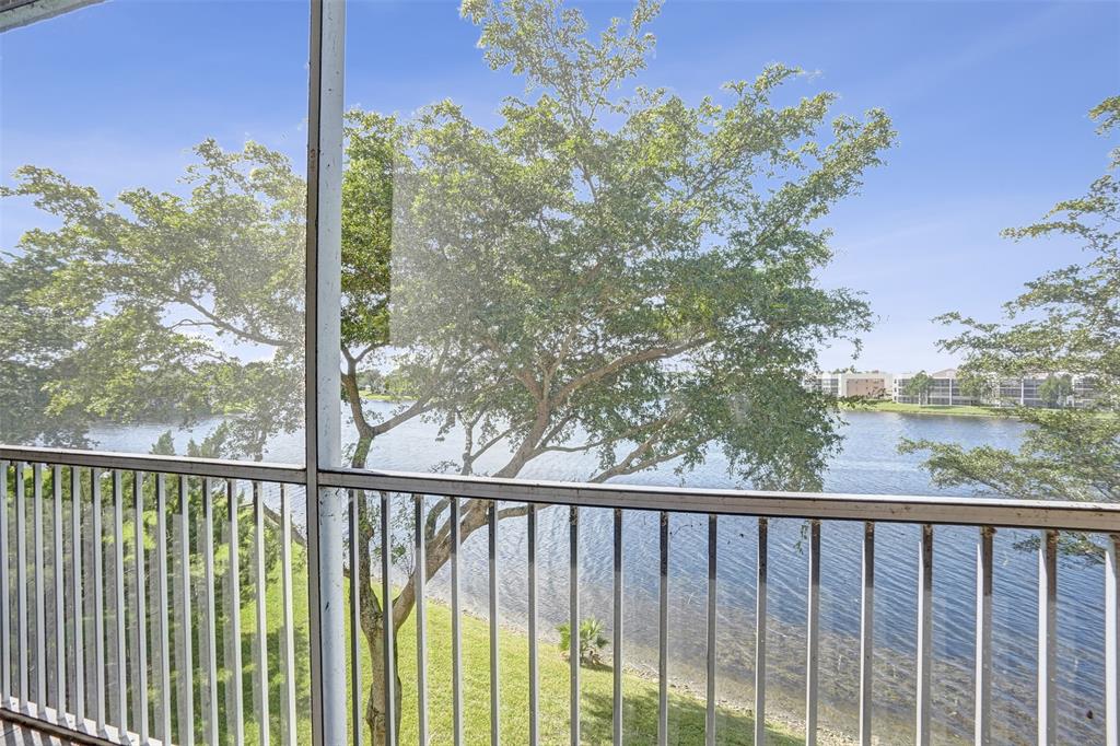 7623 Southampton Terrace, Unit 302 Tamarac, FL 33321 - Photo 17 of 43 a view of a balcony with wooden fence