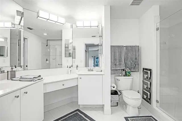 a bathroom with a toilet a sink a tub and mirror