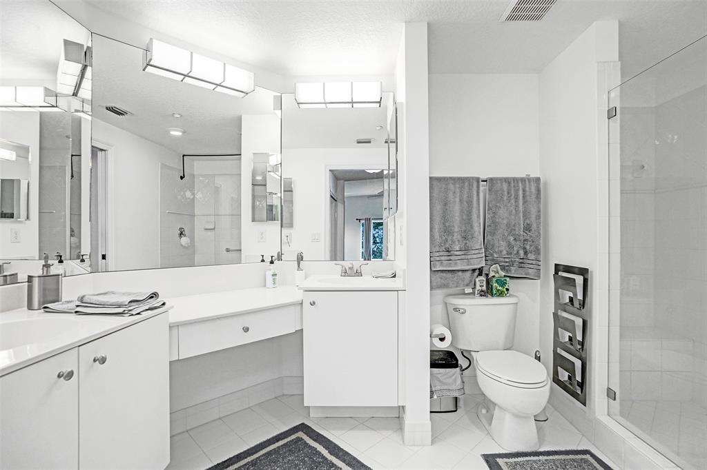 7623 Southampton Terrace, Unit 302 Tamarac, FL 33321 - Photo 22 of 43 a bathroom with a toilet a sink a tub and mirror