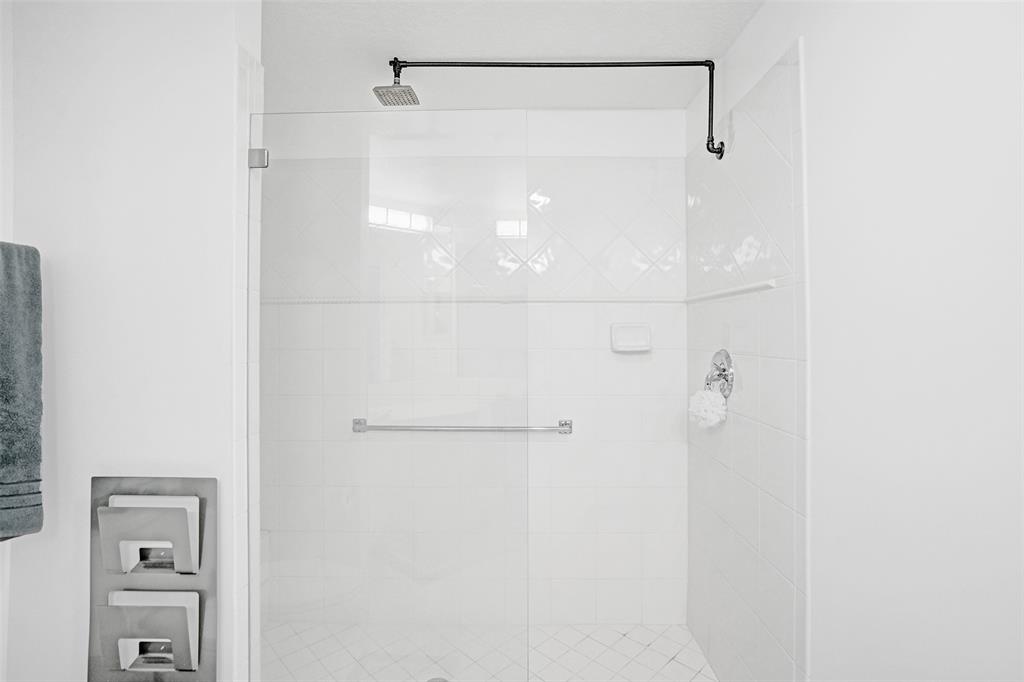 7623 Southampton Terrace, Unit 302 Tamarac, FL 33321 - Photo 24 of 43 a bathroom with a glass shower door