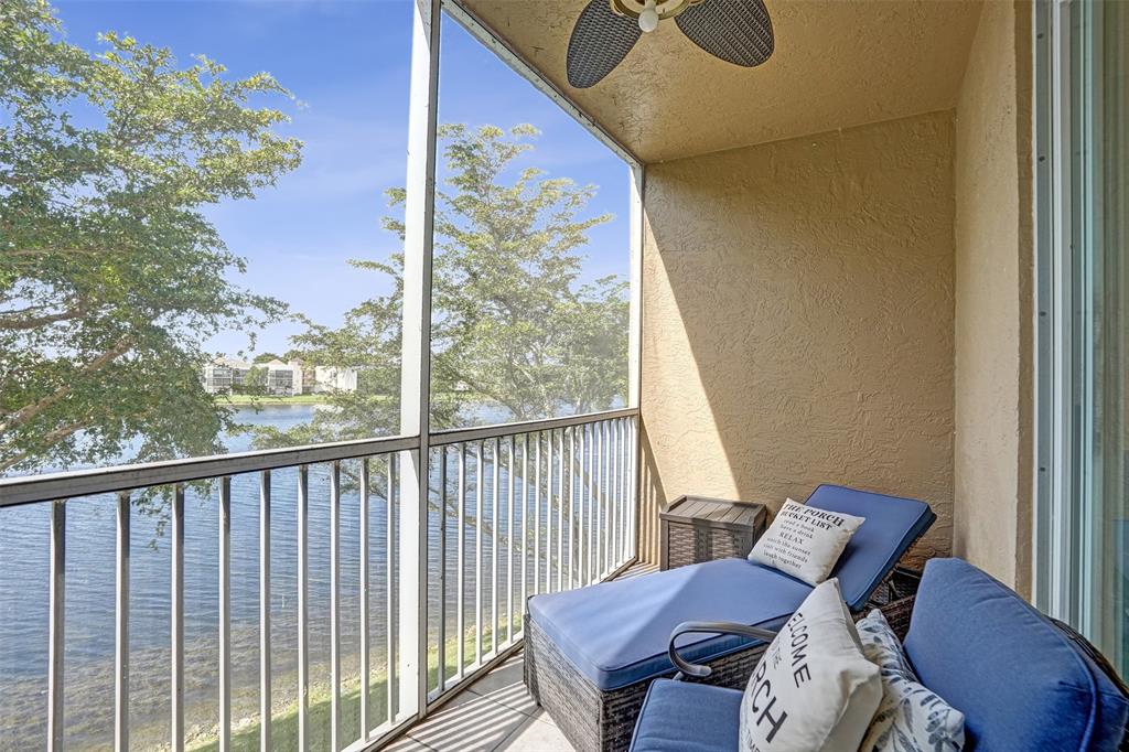 7623 Southampton Terrace, Unit 302 Tamarac, FL 33321 - Photo 28 of 43 a view of a balcony with chair and wooden floor