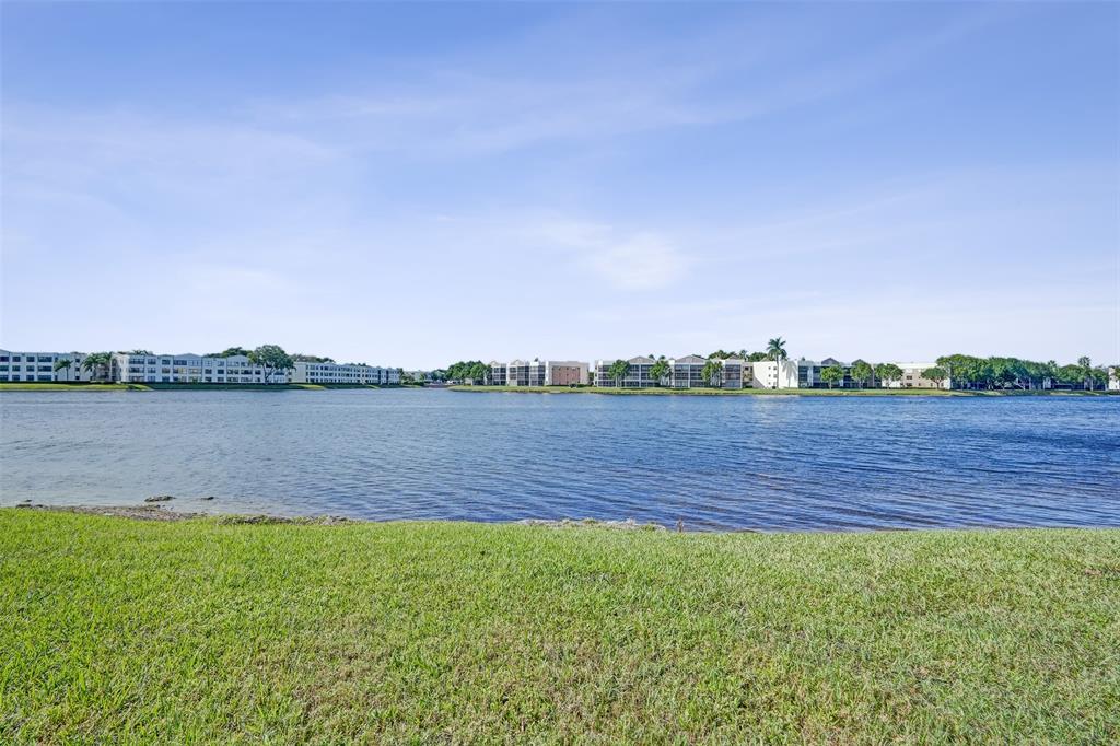 7623 Southampton Terrace, Unit 302 Tamarac, FL 33321 - Photo 30 of 43 a view of a lake with houses in the back