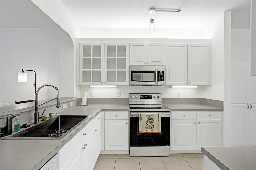 7623 Southampton Terrace, Unit 302 Tamarac, FL 33321 - Photo 6 of 43 a kitchen with cabinets appliances a sink and a window