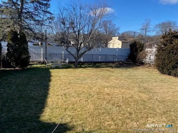 a view of a patio with a table and chairs under an umbrella